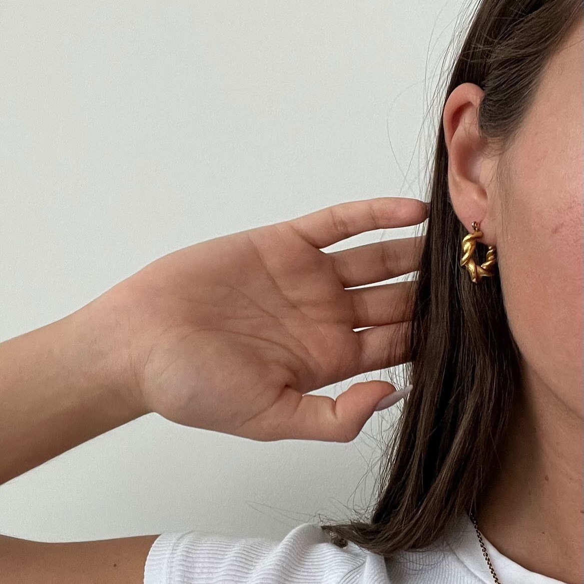 A close-up of a gold hoop earring