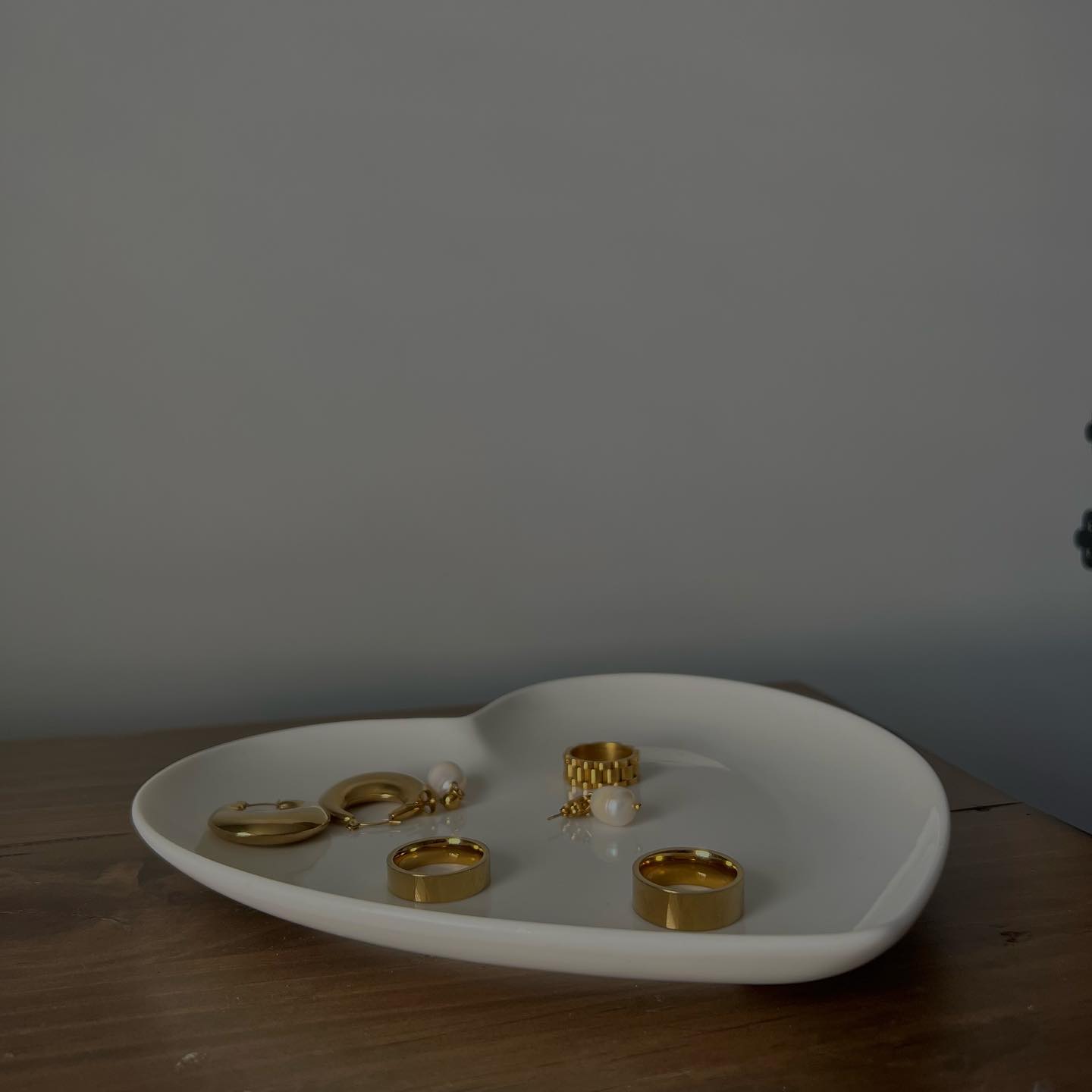 Gold jewelry arranged on a white tray