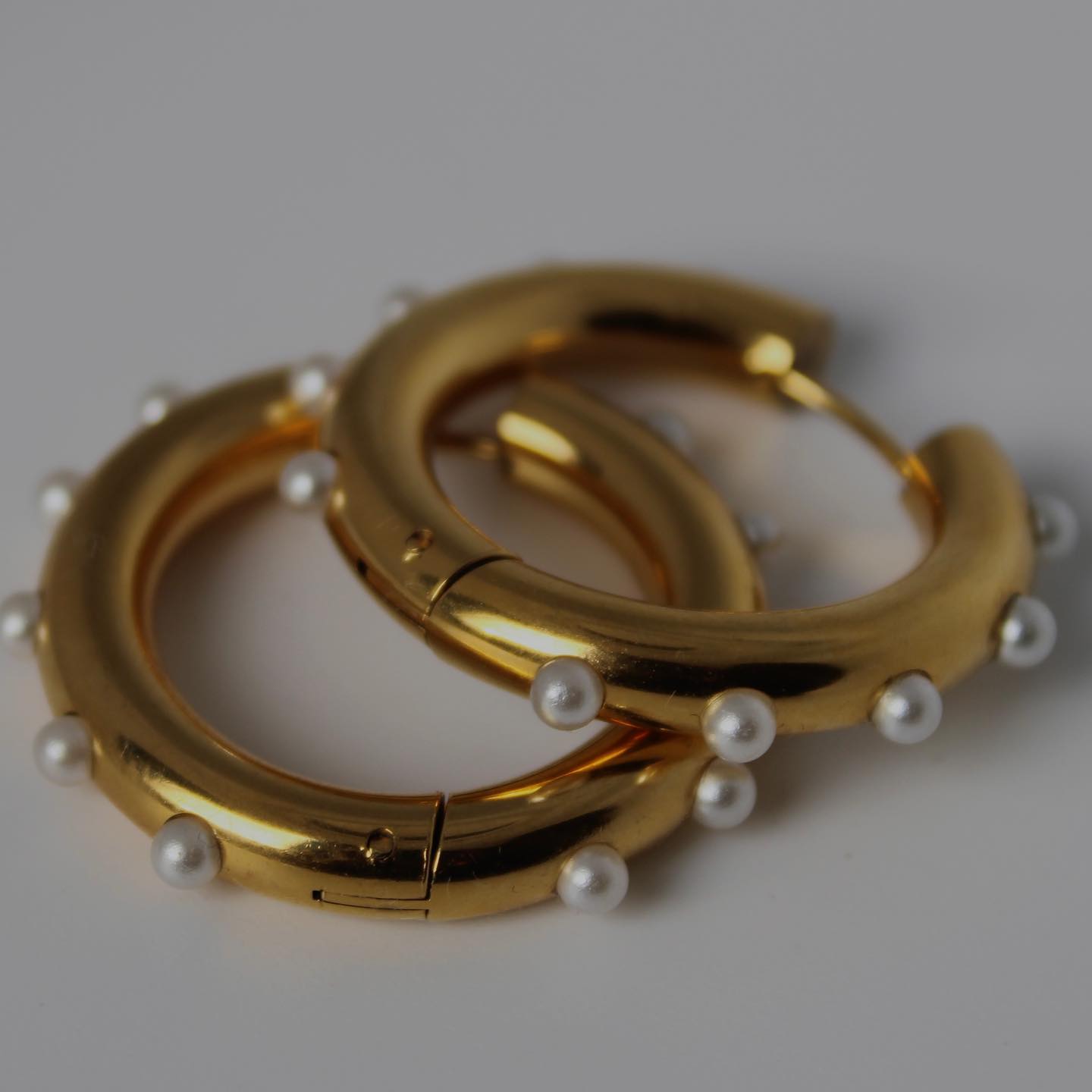 Gold hoop earrings with pearl drops